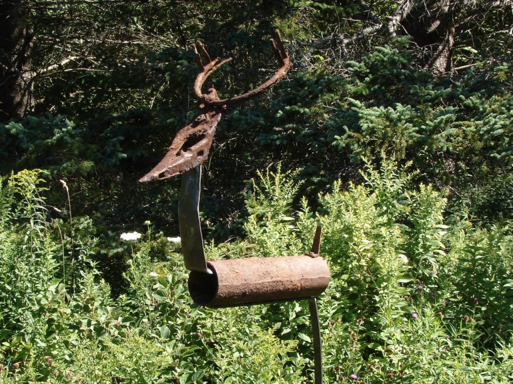 rusty stag sculpture in garden